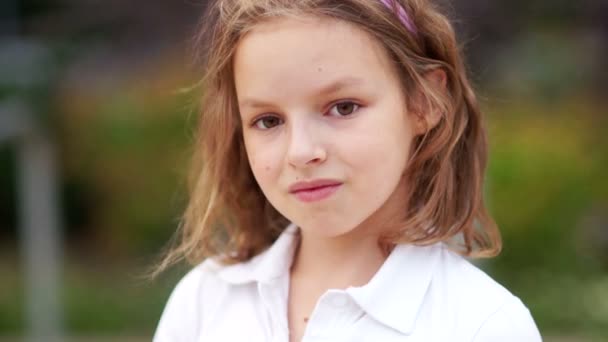 The curly girl looks into the camera with a half-smile, coquettishly and confidently. Young model, natural beauty — Stock Footage The curly girl looks into the camera with a half-smile, coquettishly and confidently. Young model, natural beauty Stock Footage