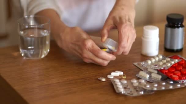 Unrecognizable woman drinks a tablet with a glass of water from a glass. Pharmacy concept — Stock Video