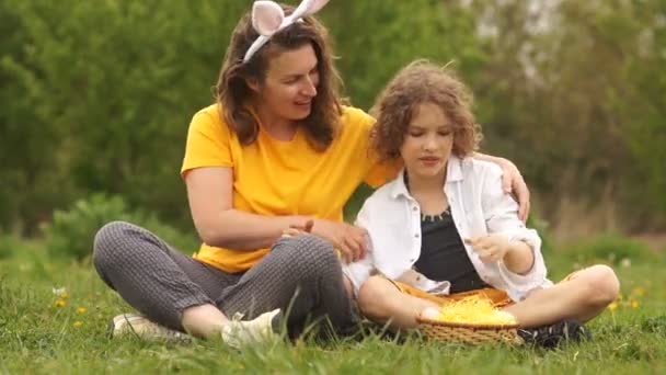 Feliz madre abraza al hijo. Fin de semana familiar en el parque. Mamá vestida de conejito de Pascua. Feliz familia de Pascua. Día de las Madres — Vídeos de Stock