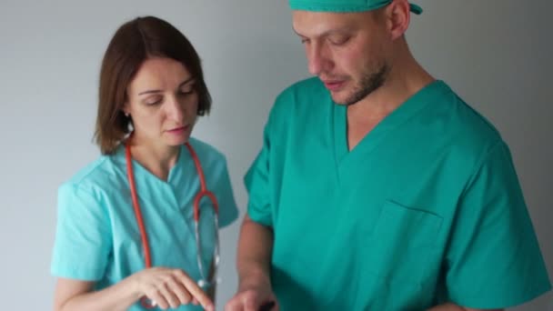 Médicos internos discutem os resultados dos exames dos pacientes. Clínica pessoal médico no trabalho, dia de médicos internacionais — Vídeo de Stock