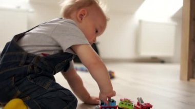 Oyuncak trenle oynayan mutlu çocuk portresi. Yerde oynayan bir çocuğun yakın Indore portresi. Mutlu çocukluk