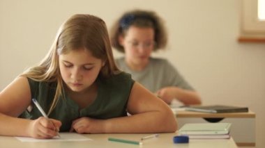 Sınıf arkadaşı başka bir öğrenciye kağıt fırlatıyor. Okul zorbalığı. Liseli kızlar ders sırasında kavga ederler.