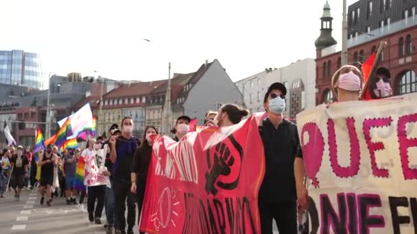 ポーランドのヴロツワフ- 2020年10月3日。市内中心部の通りに虹色の旗を持つ多くの人々がlgbtゲイパレードを歩く — ストック動画