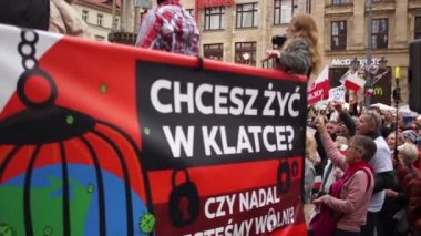 Wroclaw, Polonya - 10 Ekim 2020 - Sahte salgına karşı büyük barışçıl protesto. Polonya bayraklı maskesi olmayan insanlar protesto ediyor. Lehçe yazıt bir kafeste yaşamak istiyor.