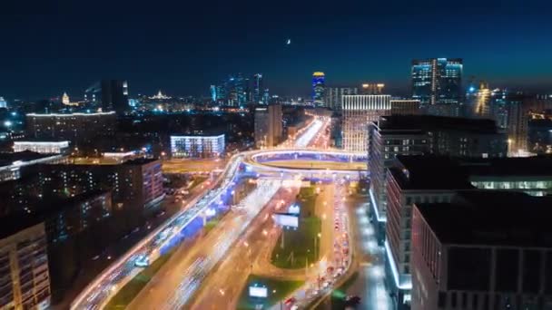 夜に忙しいモスクワ高速道路の驚くべき動きのタイムラプス 上から見て 交通量の多い市内中心部の交差点の航空写真ときらめく街灯 8K超高精細映像 — ストック動画