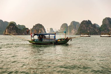 Halong Bay, Vietnam - 24 Ekim 2017: Halong Bay, Vietnam'da seyir balıkçı teknesi. Halong Bay UNESCO Dünya Miras Listesi ve Hanoi yanında en çok ziyaret edilen bir yer olduğunu.