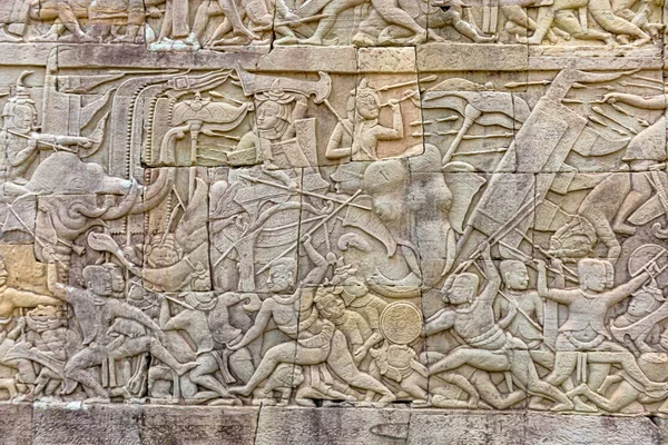 Wall carvings at Bayon temple. It is richly decorated Khmer temple at Angkor in Cambodia. Built in the late Wall carvings at Bayon temple. It is Khmer temple at Angkor in Cambodia. Built in 12th century as the official state temple of the Mahayana Bu