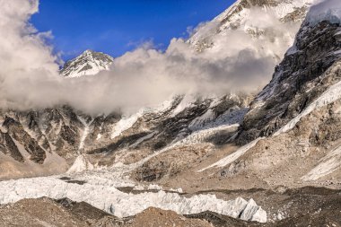Khumbutse tepesindeki panoramik manzara bulutlardan çıkıp Nepal 'deki Khumbu Buzulu' nun üzerinden Everest Üssü 'ne yaklaşıyor..