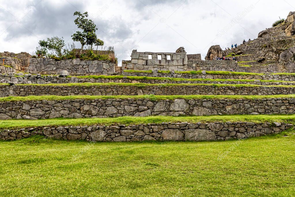 View at terraces and Temple of the Three Windows in ancient city of Incas in Machu Picchu, Peru.