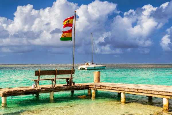 Deck and the Guna people flag on Caribbean San Blas island at politically autonomous Guna territory in Panama. It is landmark travel destination in Central America.