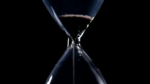 Sand Flow Hourglass End Time Sand Black Background Lateral Light — Stock Video