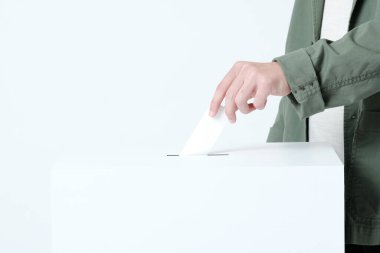 Hands of a young man putting a ballot in an election ballot box clipart