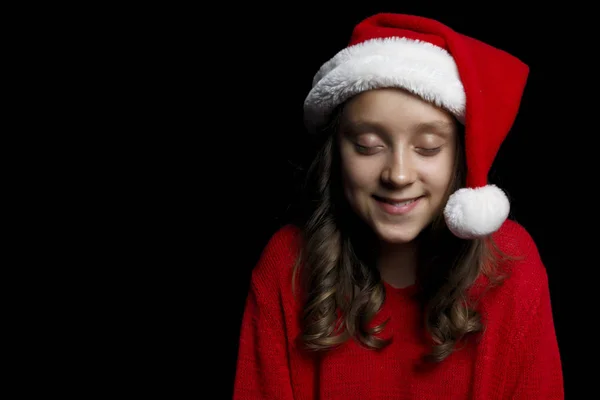 Счастливого Рождества Молодая Девушка Красном Свитере Шляпе Санта Клауса Смотрит — стоковое фото