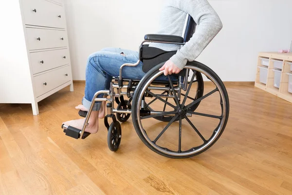 Handicapped man in wheelchair at home.