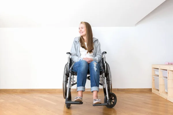 Handicapped woman sitting in wheelchair and smile.