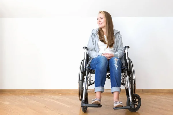 Handicapped woman sitting in wheelchair and smile.