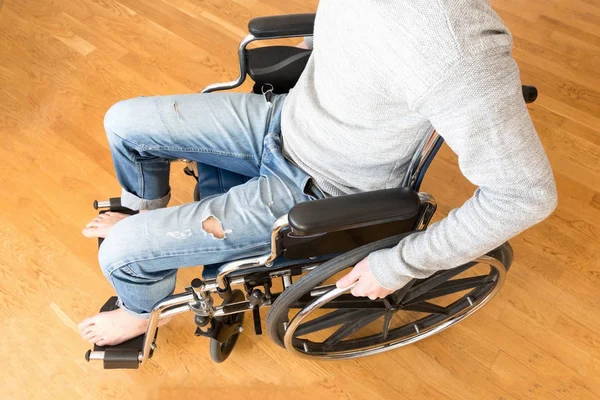 Handicapped man in wheelchair at home.