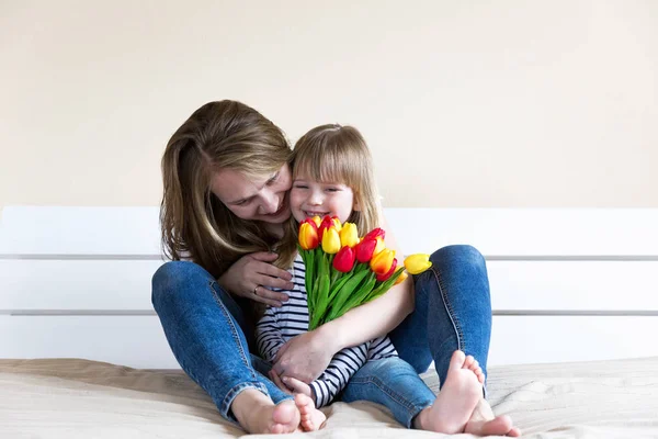 Mother and daughter holding tulip flowers