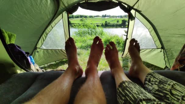 観光テントに横たわる男女の足と動き. — ストック動画