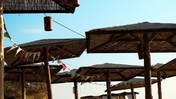 Decorated Straw Sunshades Windy Morning Sea Beach Sky Background — Stock Video