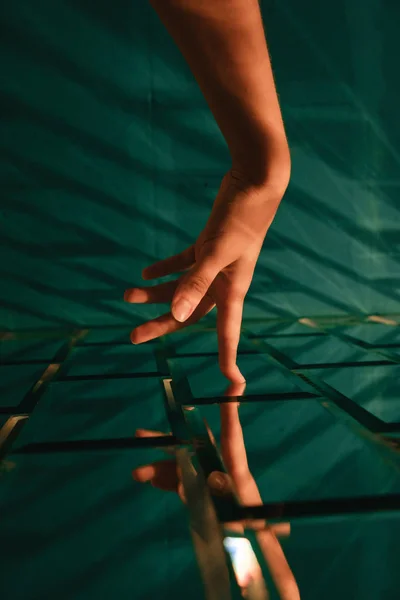 Female hand touching stylized designer brick glass wall — Stock Photo, Image