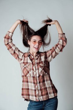 Sevimli genç esmer kız ile oynarken lumbercheck onay gömlekli