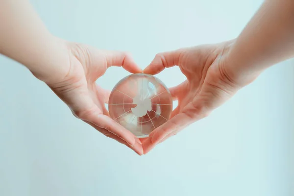 Ręce w kształcie serca, trzymając szkło globe biegun południowy — Zdjęcie stockowe