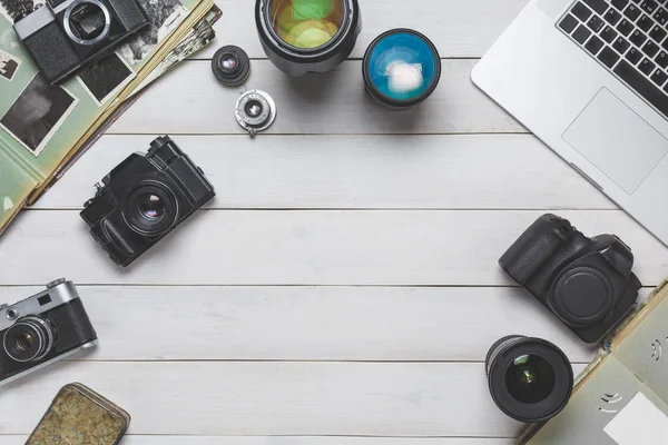 Vintage film camera, dslr camera and notebook. technology development concept. Top View