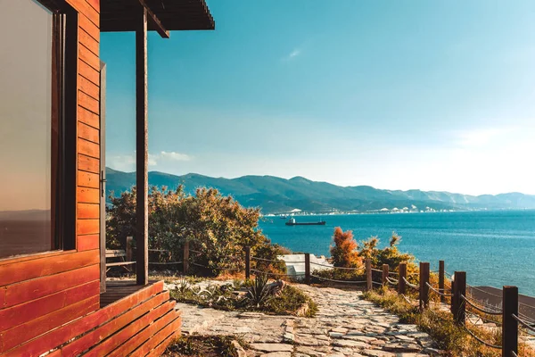 Wooden house by sea and mountain perfect landscape view sunset. Scenery vacation relaxation recreation holiday concept