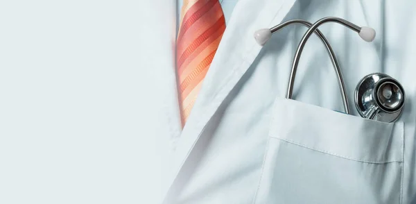 Global medicine Ana Health Care Concept. Unrecognizable doctor in white coat with stethoscope, closeup