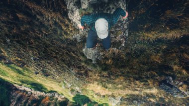 Dağlar havadan görünümü seyahat yaşam tarzı macera tatil konsepti ile Cliff köprü kenarında oturan uzun yürüyüşe çıkan kimse adam