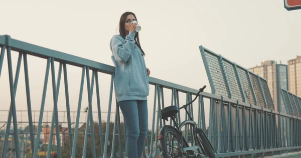 Pretty hipster girl with cup of coffee — Stock Photo, Image