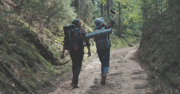 Homem jovem e mulher caminhadas na floresta — Fotografia de Stock