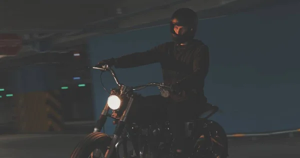 Biker riding on motorcycle in parking lot — Stock Photo, Image