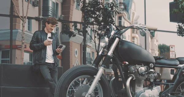 Ποδηλάτης πίνοντας καφέ, ενώ στέκεται κοντά μοτοσικλέτα — Φωτογραφία Αρχείου