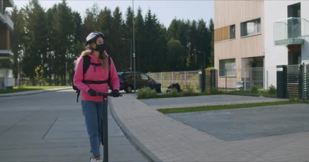 Hurtigmatleveringsbud kjører elektrisk scooter – stockvideo