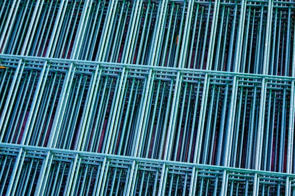 package of galvanized steel panels for the fence with a powder coated green color close-up