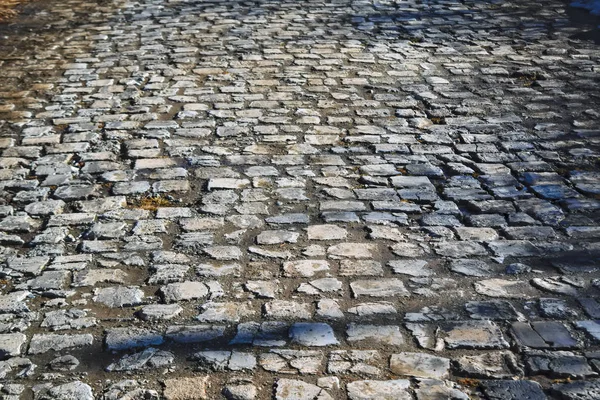 Sten trottoar konsistens. Granit kubb stenad trottoar bakgrund. — Stockfoto
