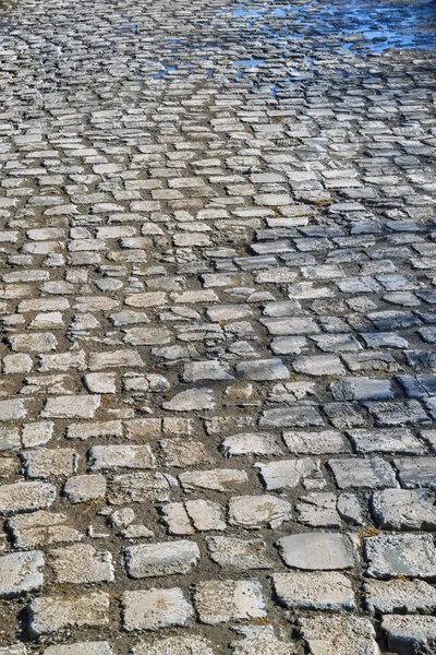 Textura do pavimento de pedra. Granito calhau apedrejado pavimento fundo . — Fotografia de Stock