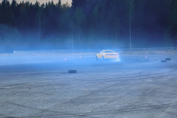 YCar drifting. Yellow sports car in the drifting competition.