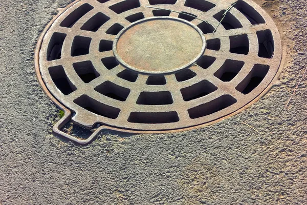 Cast-iron manhole of the storm sewer system in the park. — Stock Photo, Image