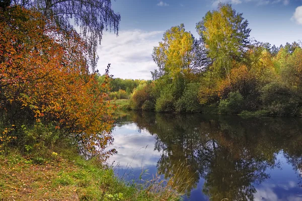 Rio de outono com árvores refletoras contra o pano de fundo de florestas e montanhas . — Fotografia de Stock