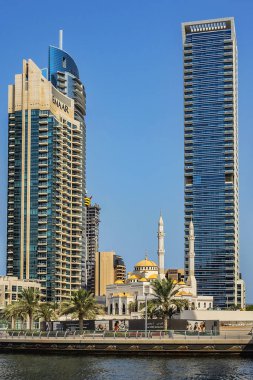 DUBAI, UAE - JULY 14, 2018: Modern skyscrapers and embankment in famous Dubai Marina. Marina - artificial canal city, carved along a 3 km stretch of Persian Gulf shoreline.