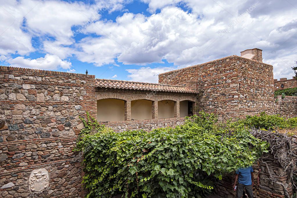 External view of Alcazaba Walls - palatial fortress in Malaga built in XI century. Fortress palace, whose name in Arabic means citadel, is one of city's historical monuments. Malaga, Andalusia, Spain.