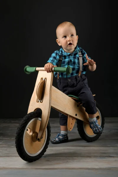 Menino Brinca Com Brinquedo Moto Madeira Estúdio — Fotografia de Stock