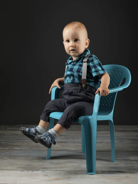 Niño Sentado Una Silla Plástico Estudio —  Fotos de Stock