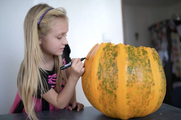 Cute Little Girl Decorating Pumpkin — Stock fotografie