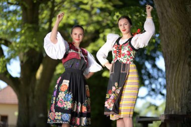 Slovak folklore dancers in traditional folklore costume clipart