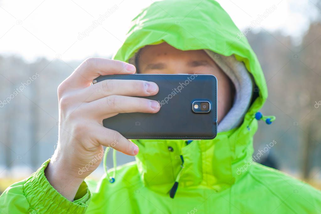 A man is taking photo with smartphone