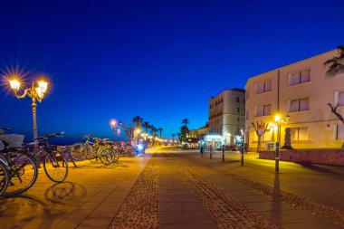 Alghero, İtalya - 10 Haziran 2017: Gece Alghero limanı üzerinde bulutlu gökyüzü.